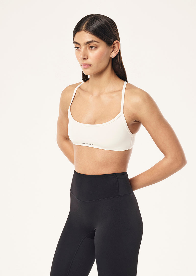 REVEAL SPORTS BRA IN WHISPER WHITE BY P.E NATION, WOMEN'S PILATES SPORTS BRAS