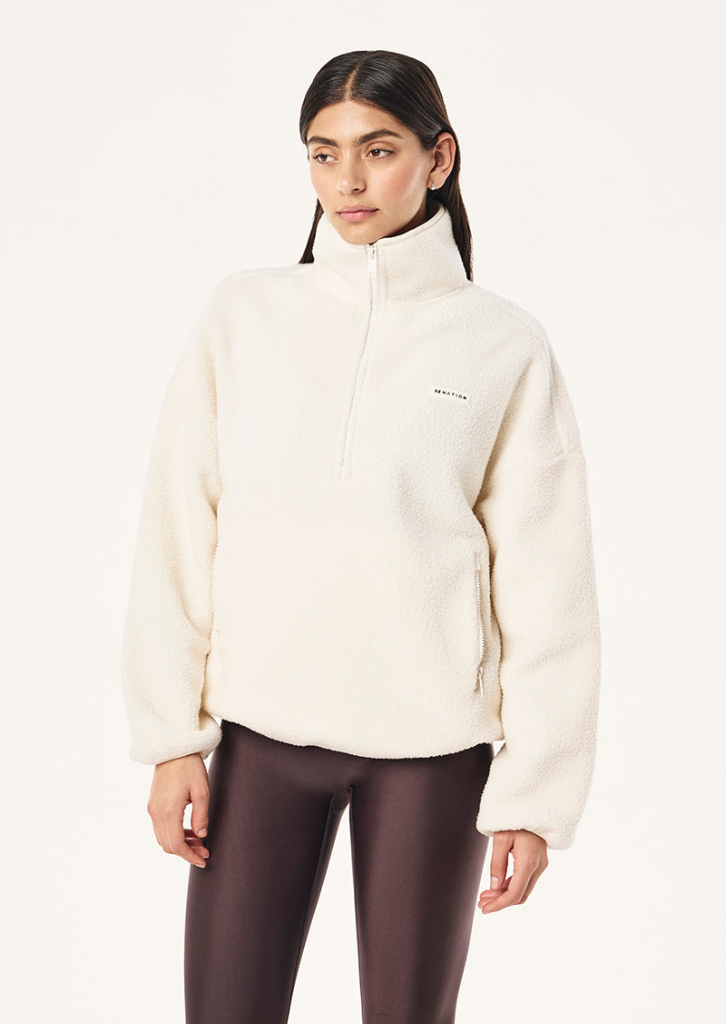 ROTATE QUARTER ZIP IN WHISPER WHITE BY P.E NATION