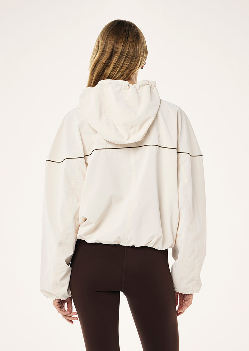 VERTEX JACKET IN WHISPER WHITE BY P.E NATION, WOMENS ATHLEISURE TRACK JACKET OUTERWEAR, CREAM