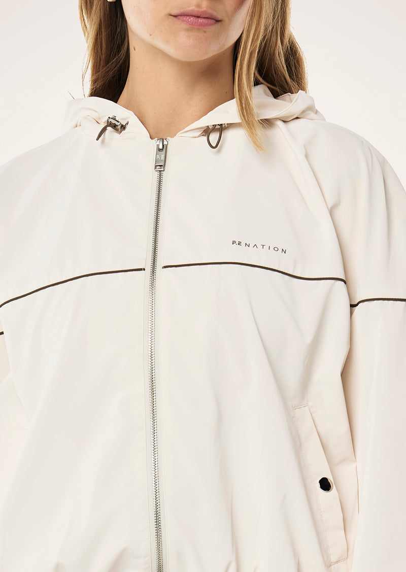 VERTEX JACKET IN WHISPER WHITE BY P.E NATION, WOMENS ATHLEISURE TRACK JACKET OUTERWEAR, CREAM