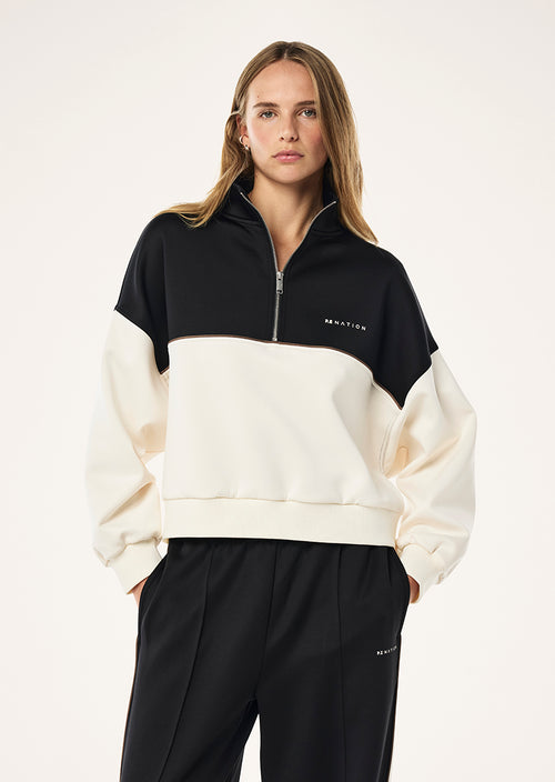 BOUNDLESS ZIP NECK SWEAT IN WHISPER WHITE BY P.E NATION 