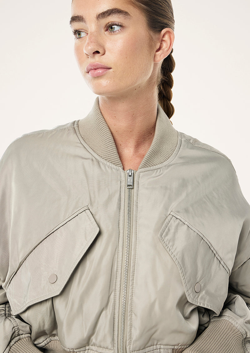CAPTIVATE BOMBER IN BISCUIT BY P.E NATION WOMENS ATHLEISURE JACKET 