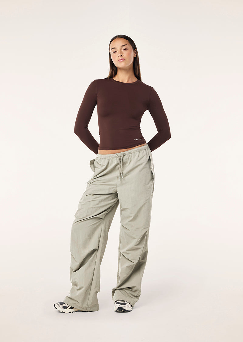 FOUNDATION LONG SLEEVE TOP IN MAHOGANY BY P.E NATION WOMENS ATHLEISURE TOP