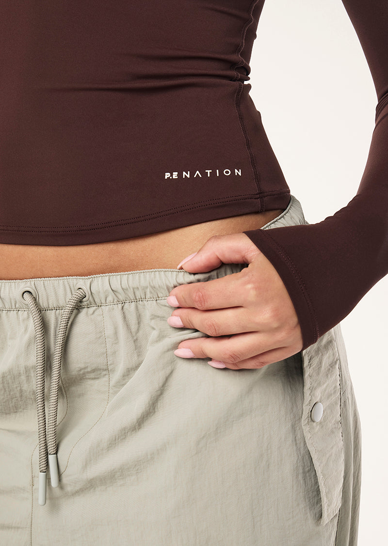 FOUNDATION LONG SLEEVE TOP IN MAHOGANY BY P.E NATION WOMENS ATHLEISURE TOP