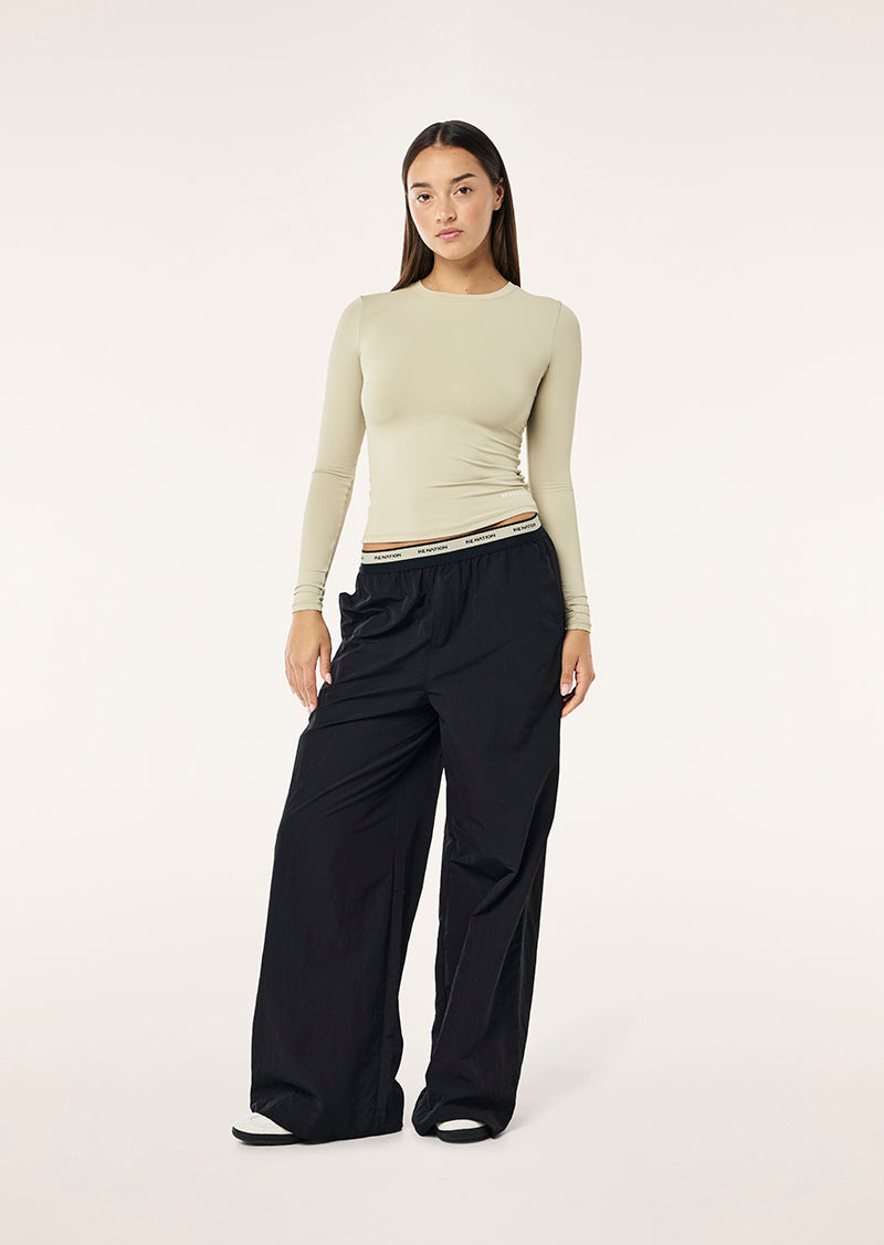 FOUNDATION LONG SLEEVE TOP IN BISCUIT BY P.E NATION WOMENS ATHLEISURE LONG SLEEVE TOP