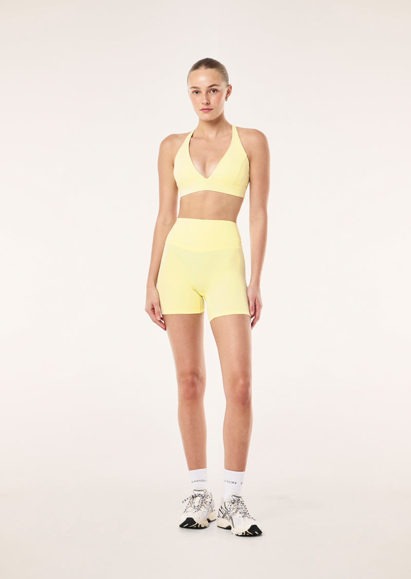 SIGNATURE 5 INCH BIKE SHORT IN SOFT YELLOW BY P.E NATION, WOMEN'S PILATES BIKE SHORT