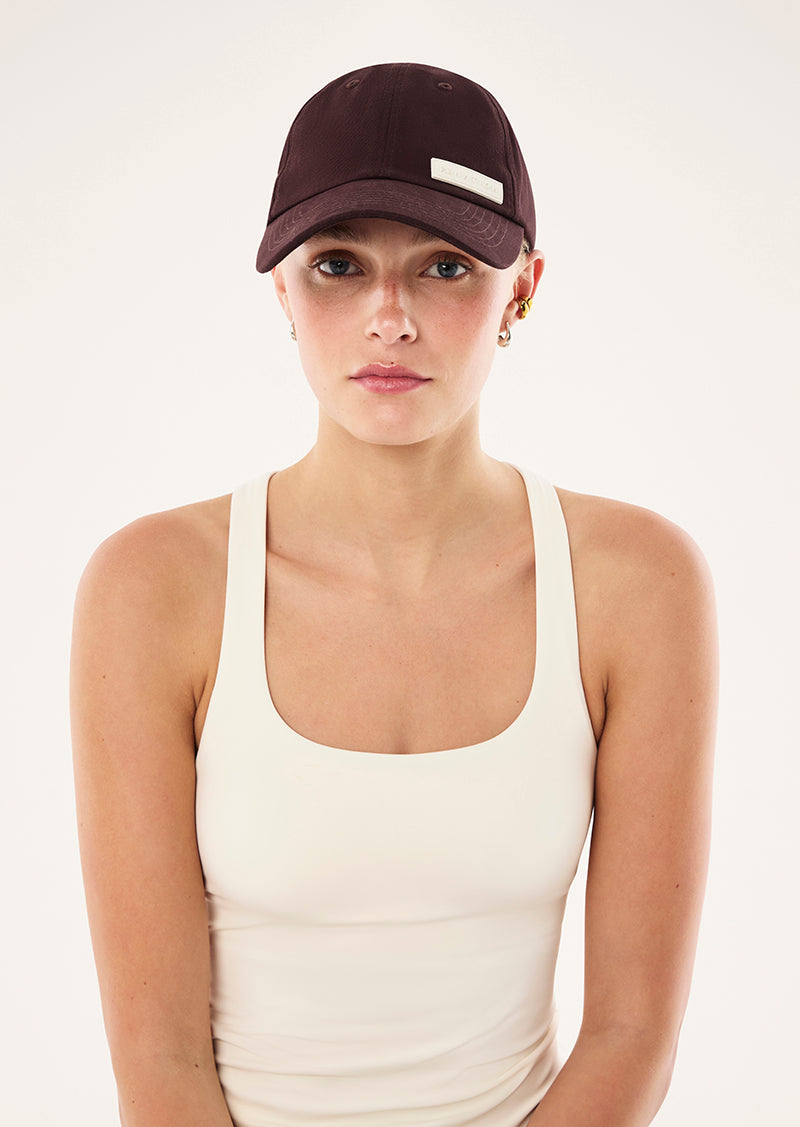 LOGO CAP IN DARK PLUM BY P.E NATION