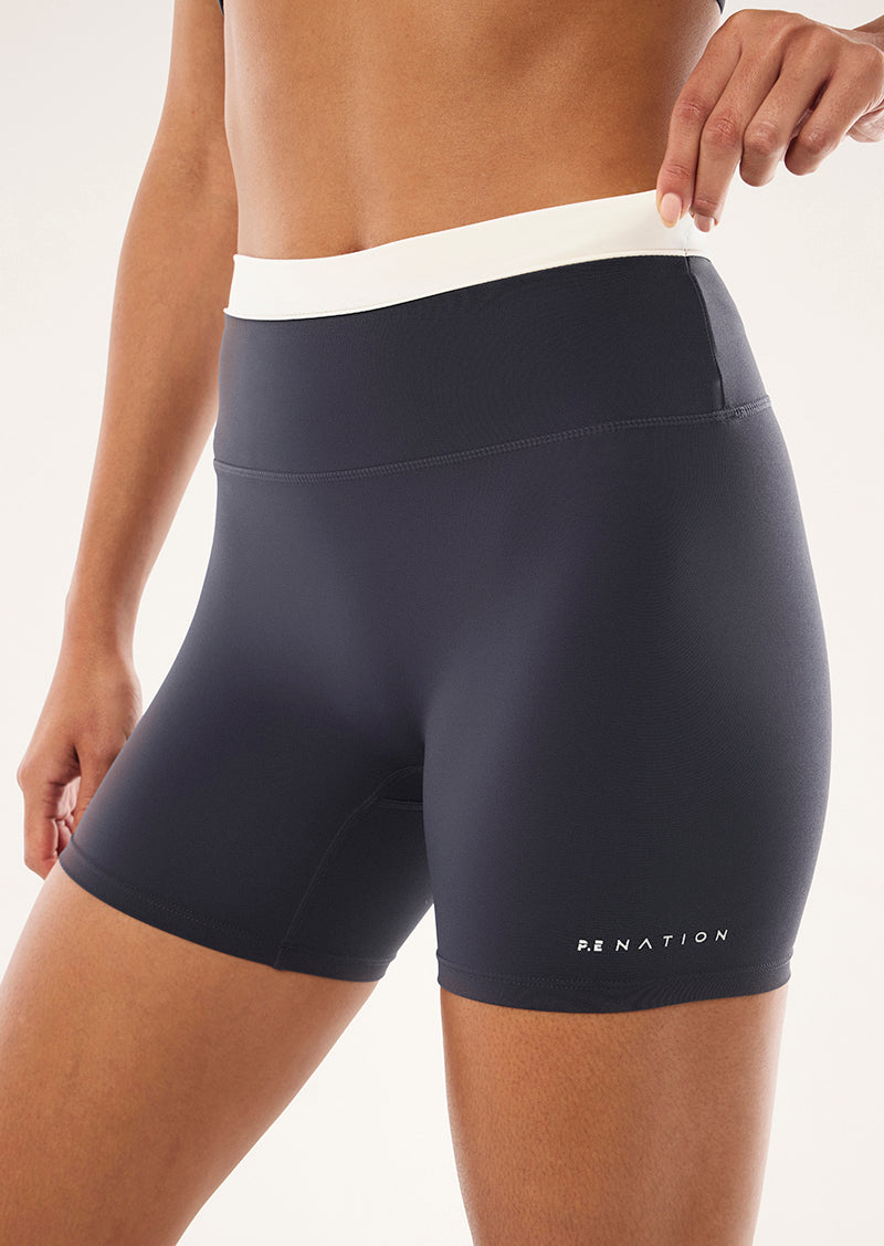 REFLECT 5 INCH BIKE SHORT IN MARINE BLUE & WHISPER WHITE BY P.E NATION, WOMEN'S PILATES BIKE SHORT