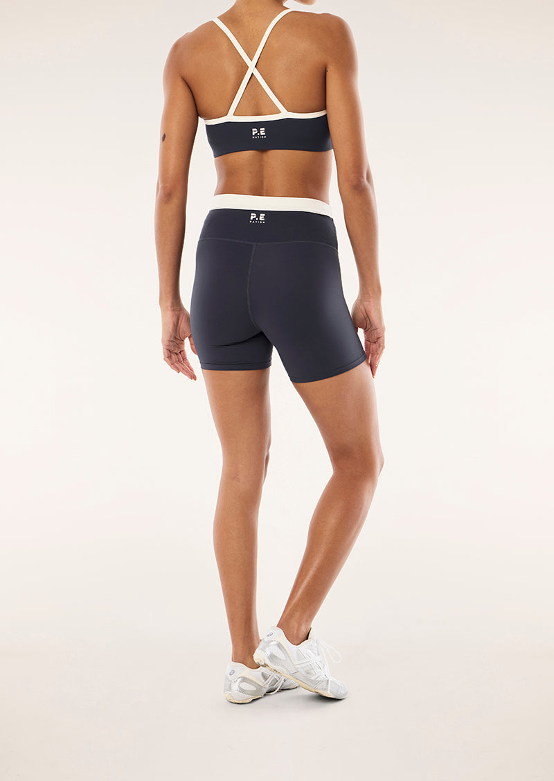 REFLECT 5 INCH BIKE SHORT IN MARINE BLUE & WHISPER WHITE BY P.E NATION, WOMEN'S PILATES BIKE SHORT