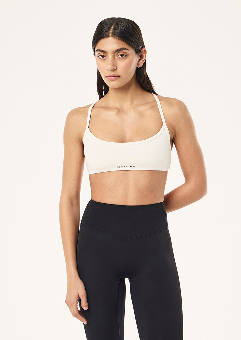 REVEAL SPORTS BRA IN WHISPER WHITE BY P.E NATION