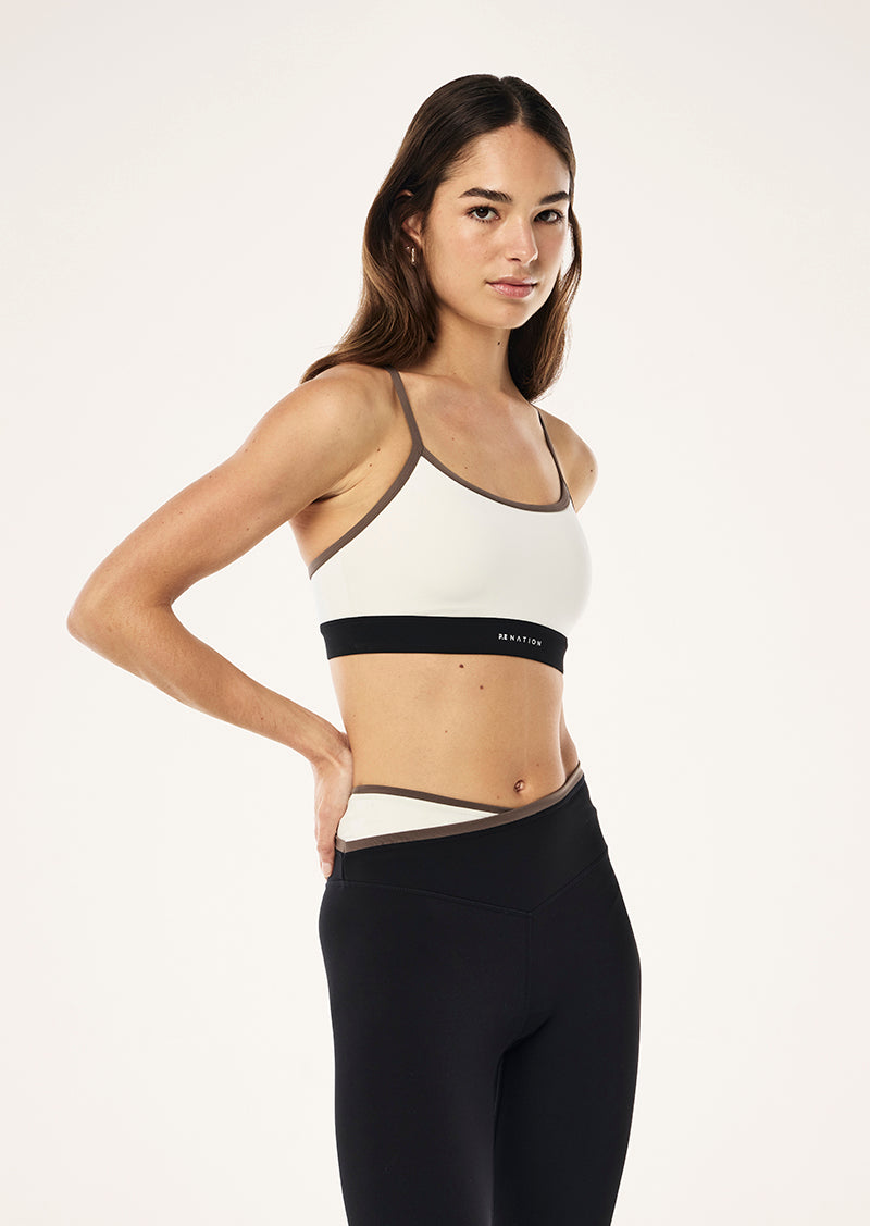 SIGNATURE SPORTS BRA IN WHISPER WHITE BY P.E NATION WOMENS SPORTS BRA CREAM 