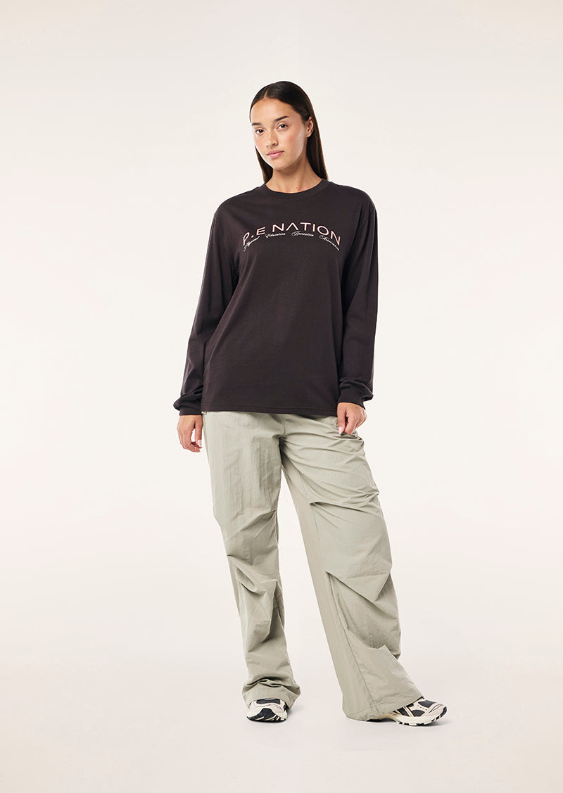 VOLUME LONG SLEEVE TEE IN LICORICE BY P.E NATION WOMENS ACTIVE TEE